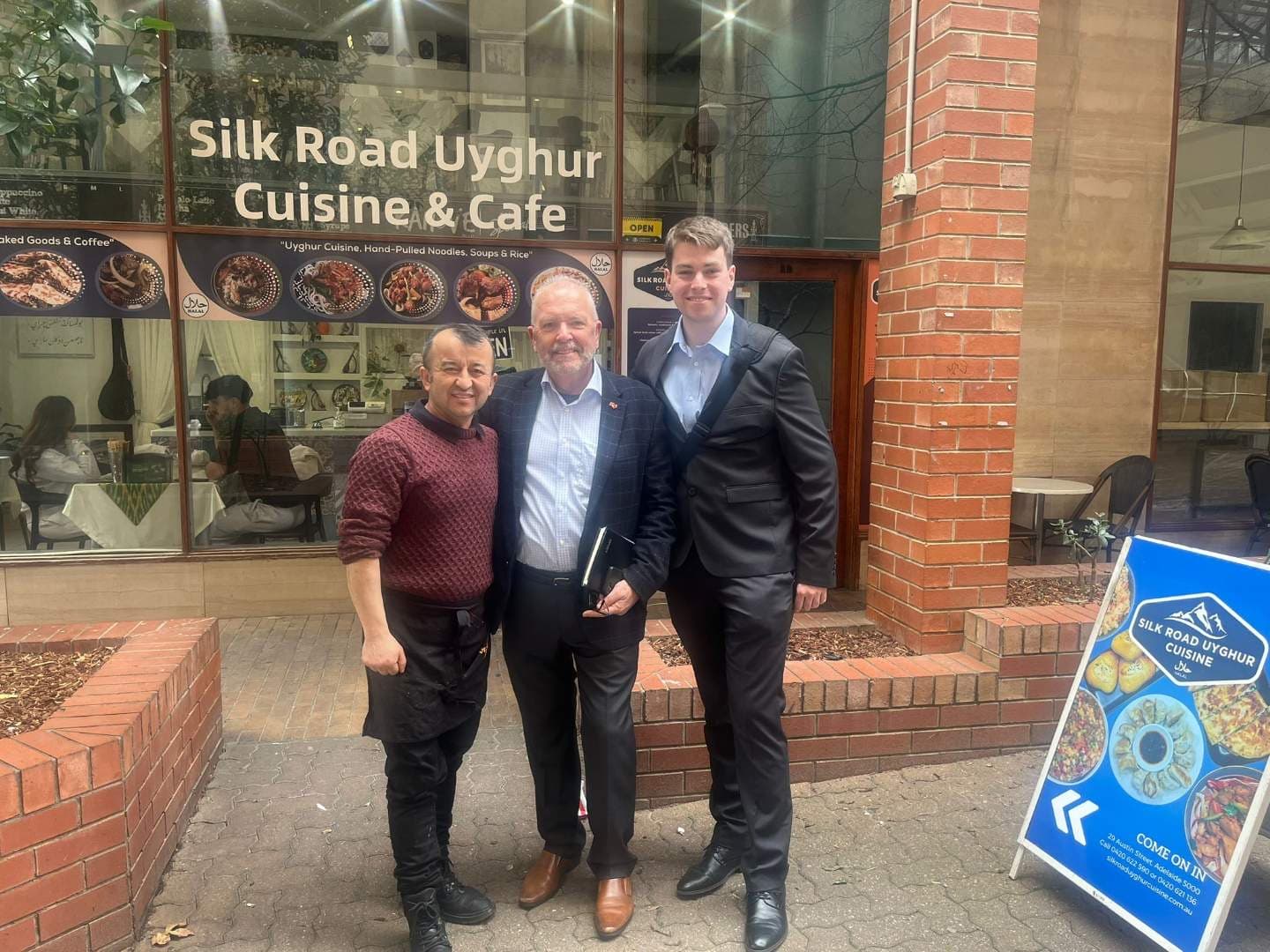 Colin Shearing with local business owners outside Silk Road Uyghur Cuisine & Cafe